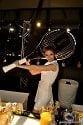 Bartendress with oversized tennis racket