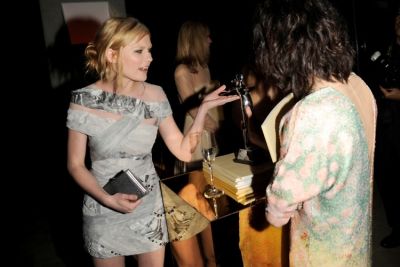 Kirsten Dunst takes a look at one of the CFDA Award Statues